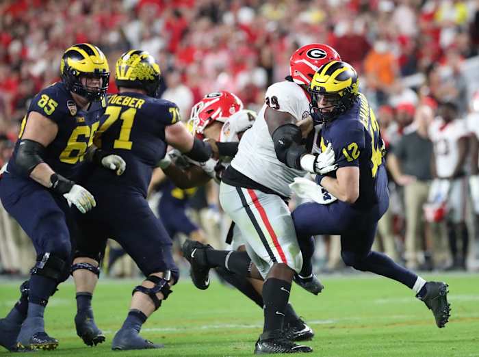 Michigan quarterback Cade McNamara is knocked down by Georgia defensive lineman Jordan Davis Kirthmon F. Dozier / USA TODAY NETWORK